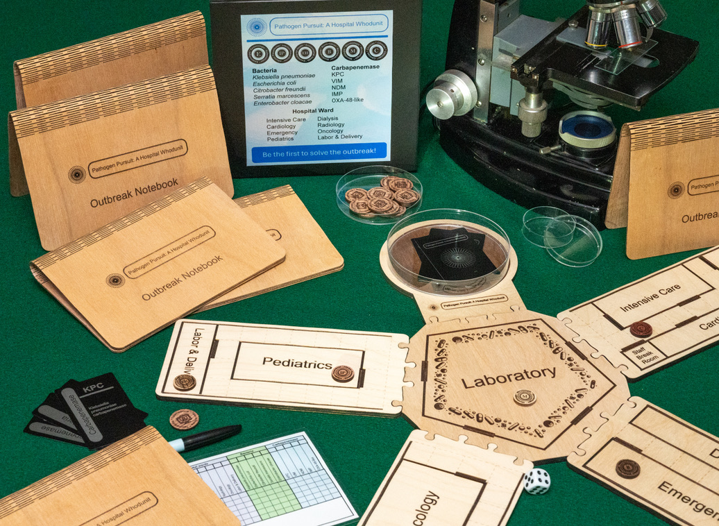 A collection of custom laser-engraved wooden game pieces, boards, and notebooks